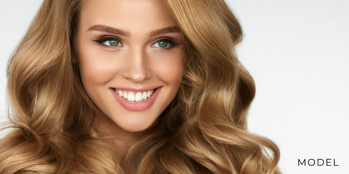 Smiling Model with Voluminous Hair