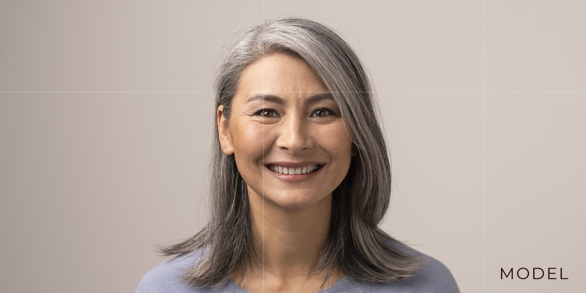 Woman with graying hair smiles | emmett plastic surgery