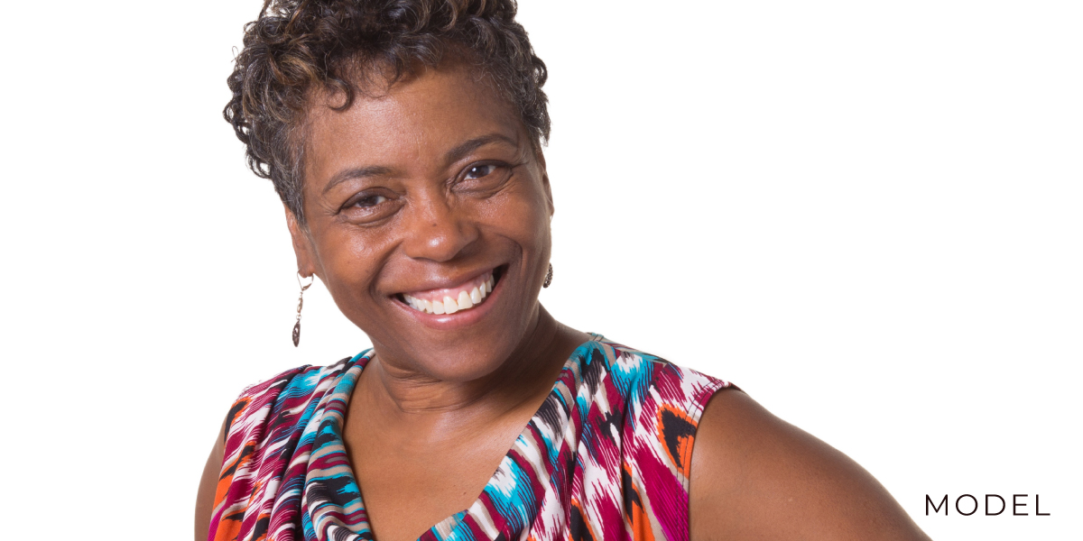 Model In Bright Top against a White Background