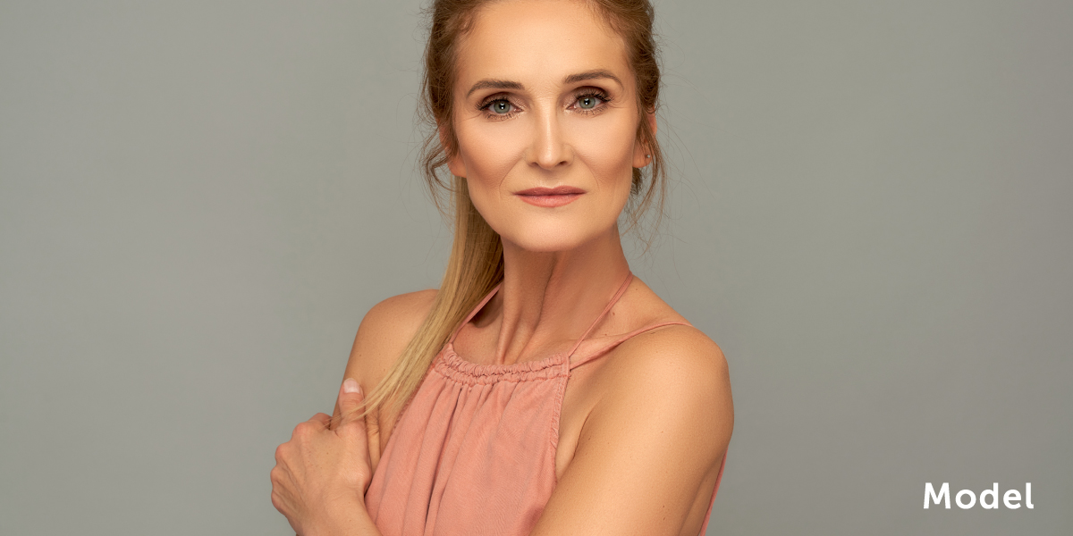 Model in Salmon Blouse Demonstrates Healthy Skin