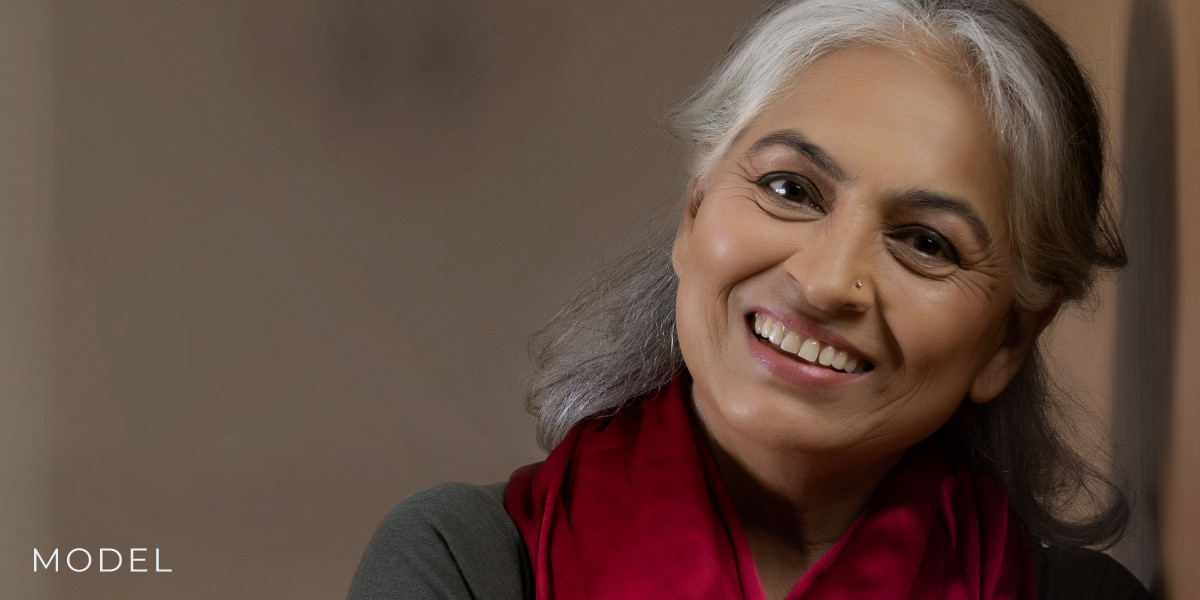 Woman with Grey Hair Leans Against a Wall