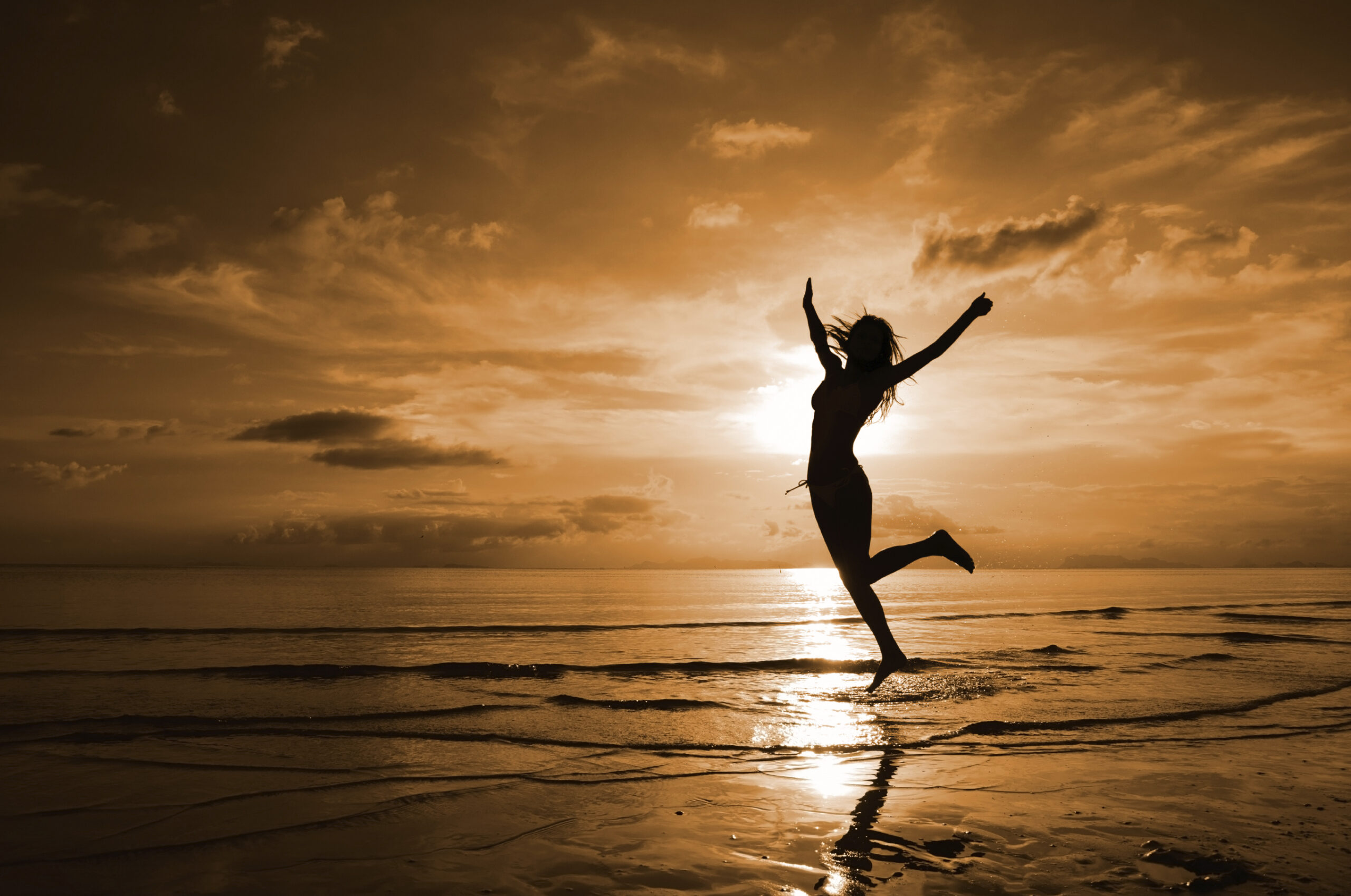 Model in Silhouette Dancing on the Beach